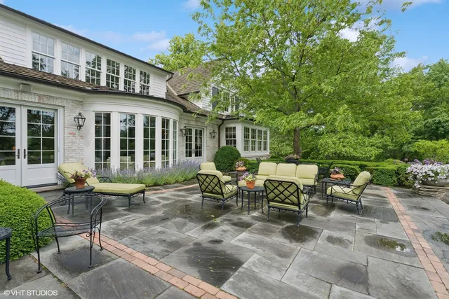 a bedroom with a bed and large windows