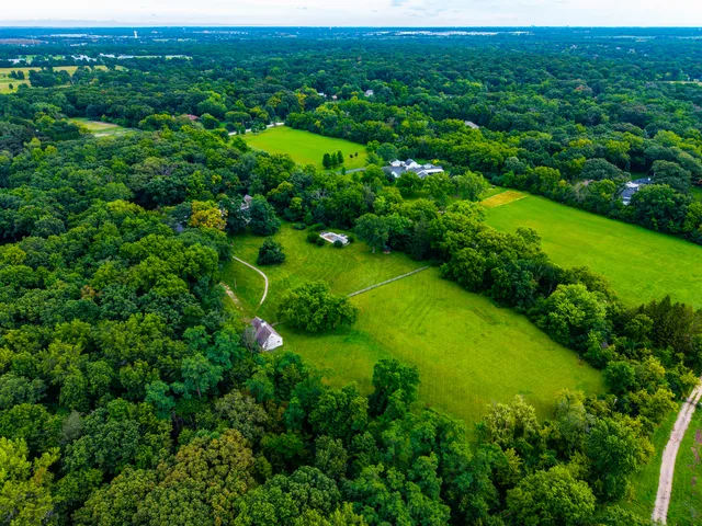 a living room with furniture large windows and a fireplace