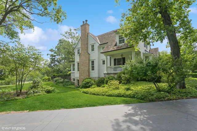 a view of a house with backyard sitting area and garden