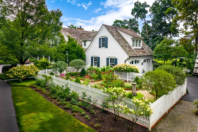 a front view of a house with a yard table and chairs