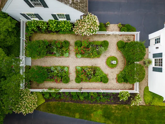 a view of a garden with a building in the background