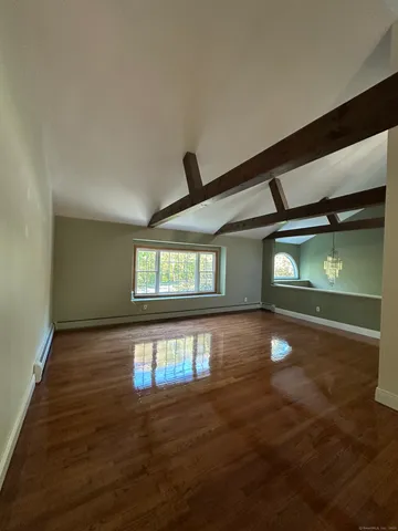 a kitchen with a table chairs microwave and refrigerator