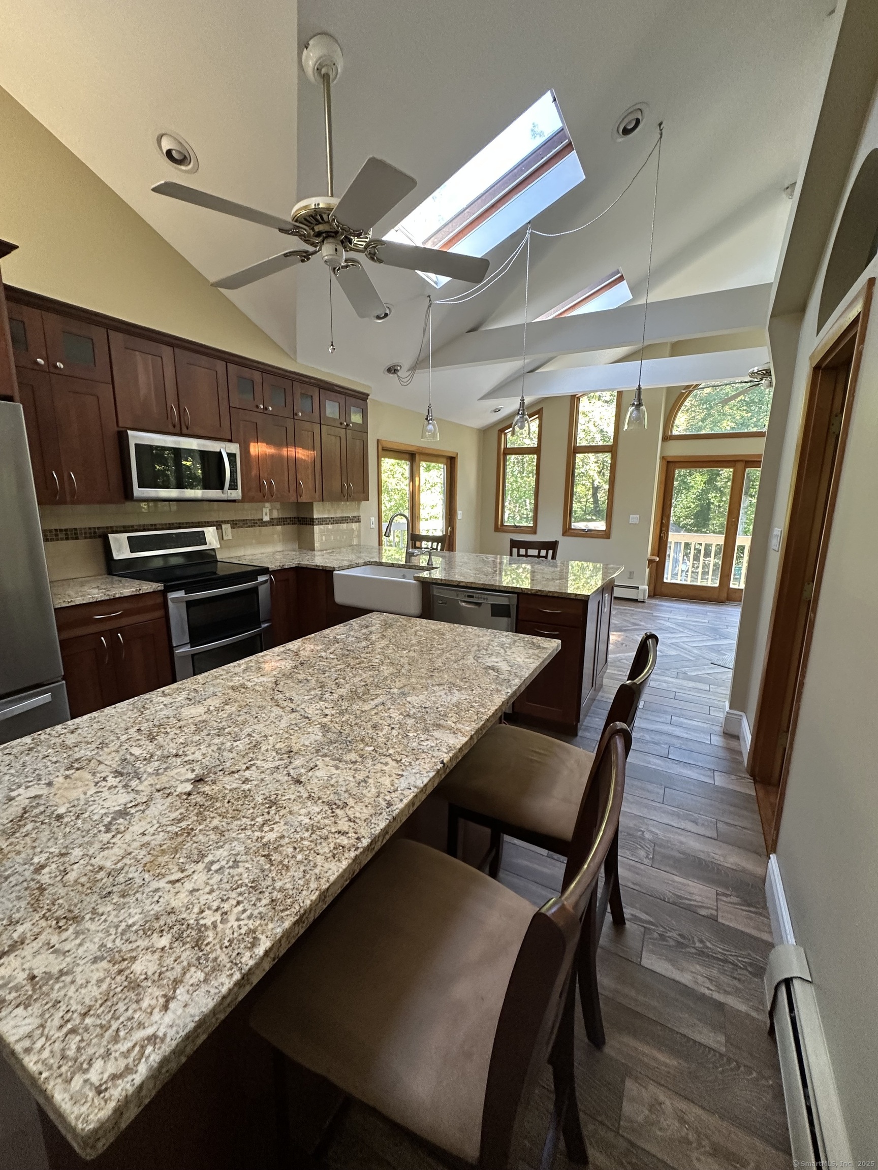 80 Woodlawn Road Monroe, CT 06468 - Photo 14 of 40 a kitchen with a table chairs microwave and refrigerator