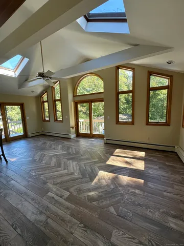 a view of a livingroom with furniture window and wooden floor
