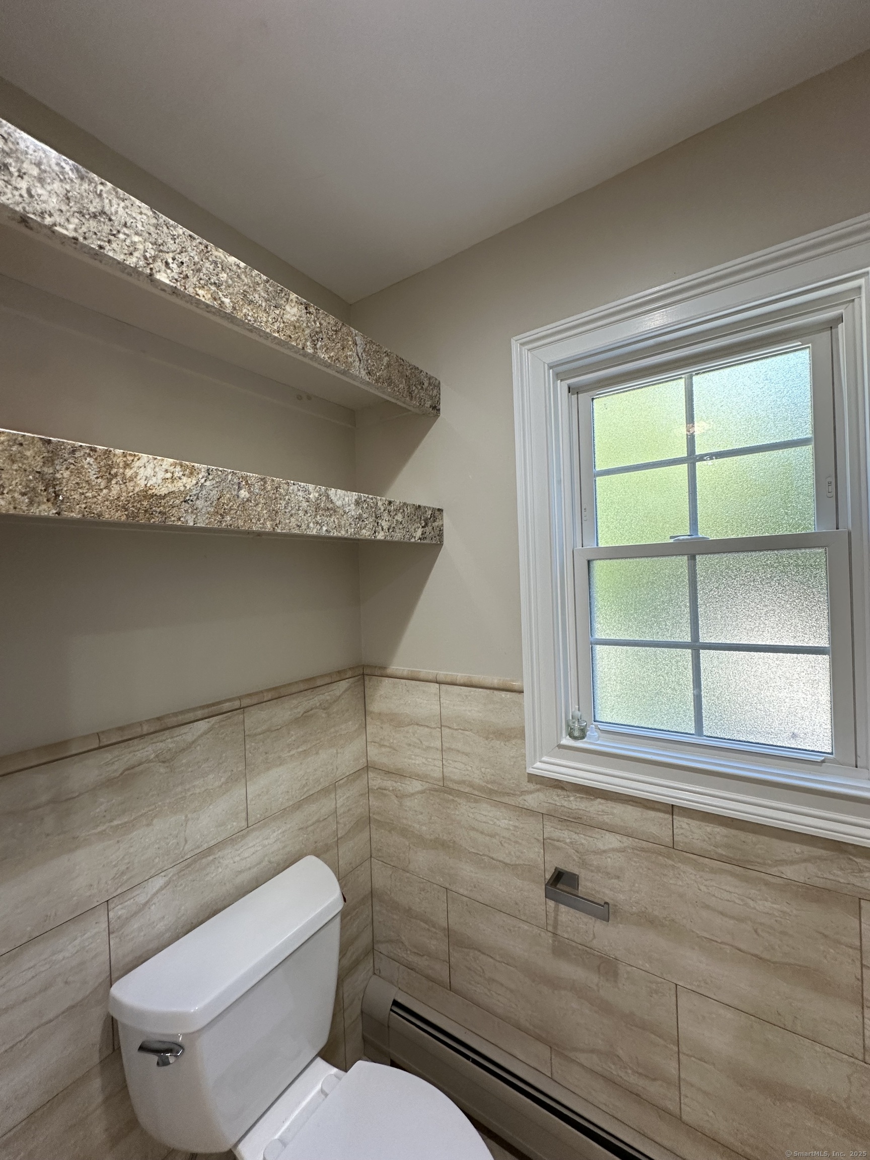 80 Woodlawn Road Monroe, CT 06468 - Photo 23 of 40 a bathroom with a toilet sink and window