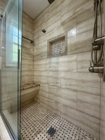 a large bathroom with a large mirror vanity and a sink