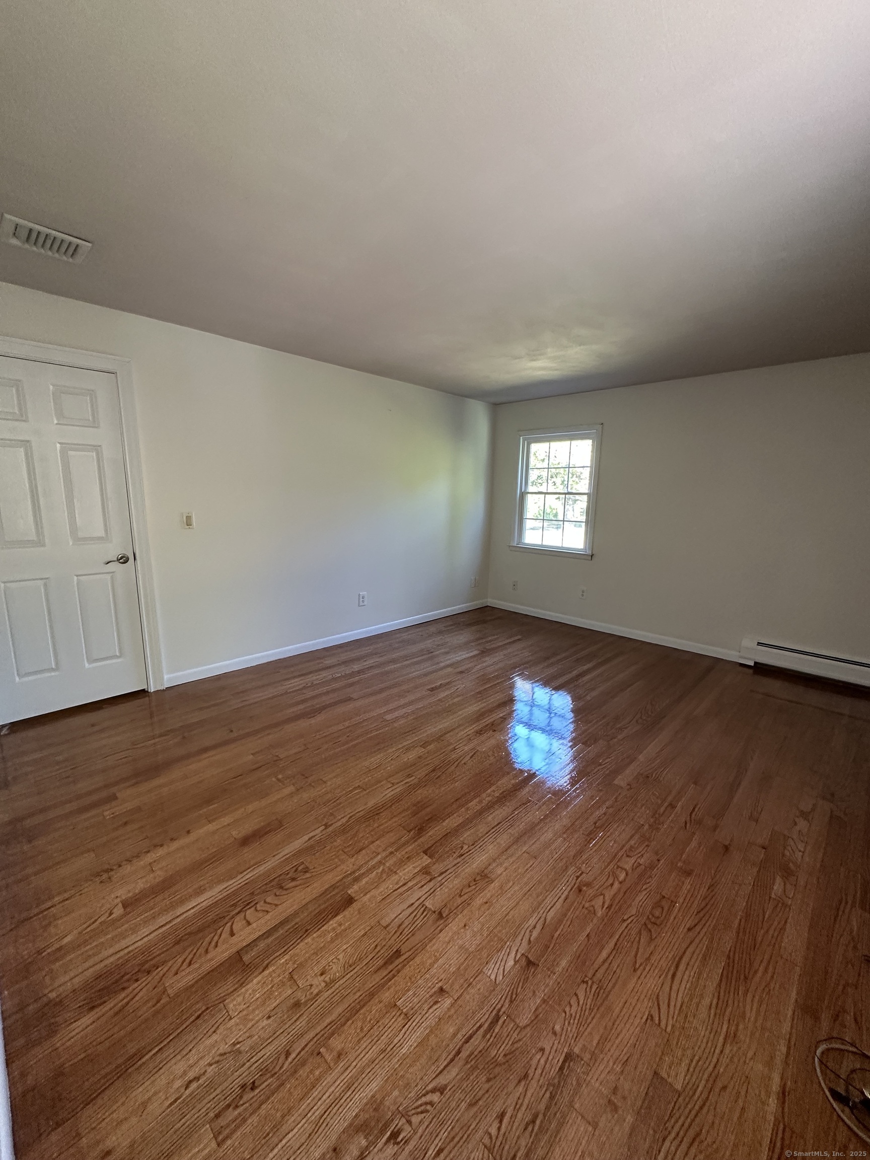 80 Woodlawn Road Monroe, CT 06468 - Photo 27 of 40 an empty room with wooden floor and windows