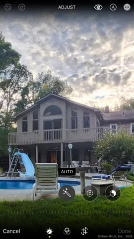 a view of a house with swimming pool and furniture