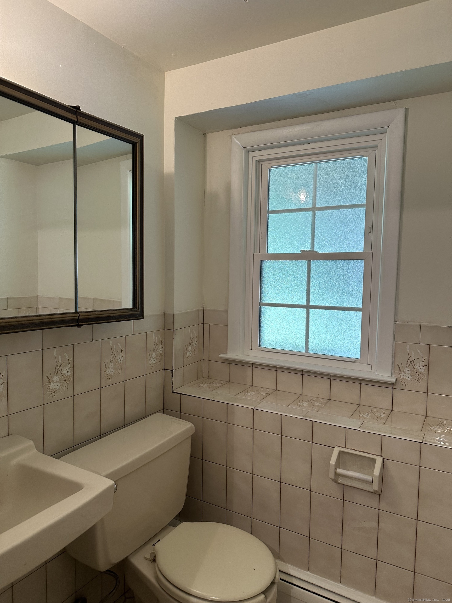 80 Woodlawn Road Monroe, CT 06468 - Photo 38 of 40 a bathroom with a toilet a sink and mirror