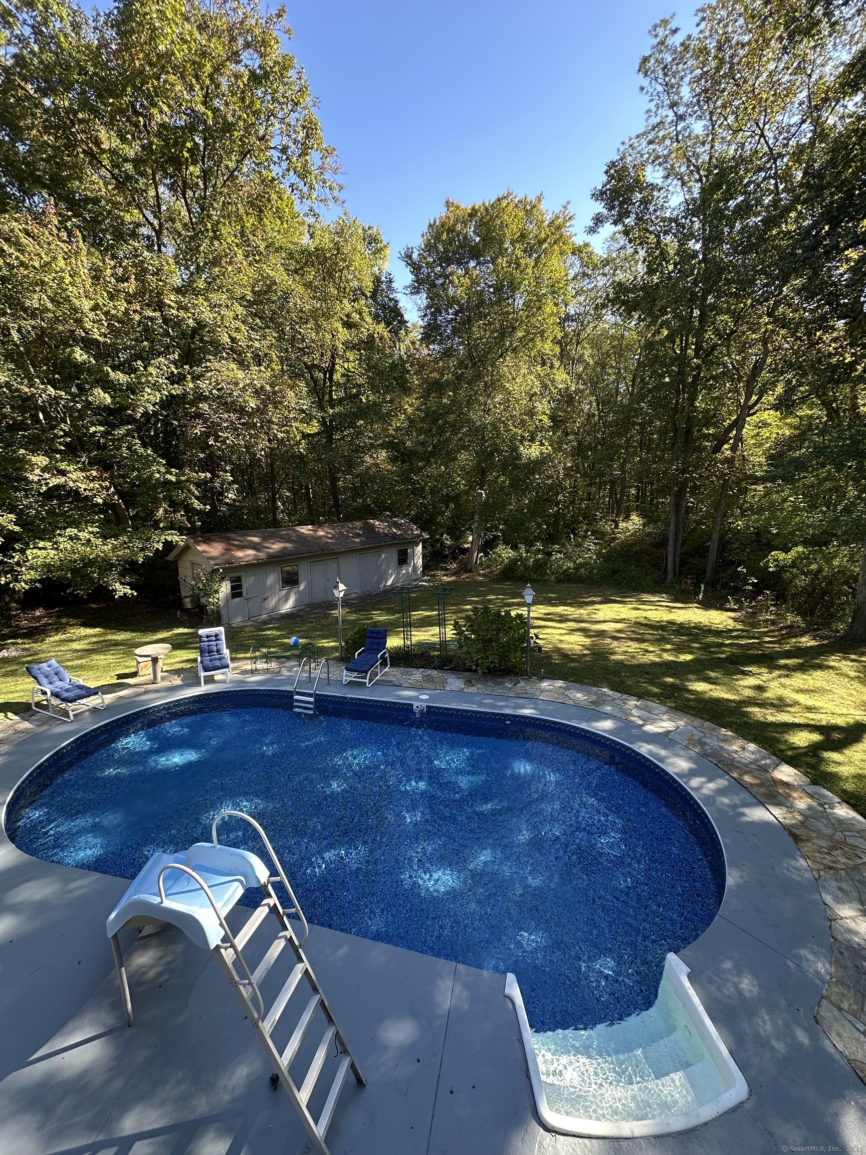 80 Woodlawn Road Monroe, CT 06468 - Photo 4 of 40 a view of a swimming pool with an outdoor space and seating area