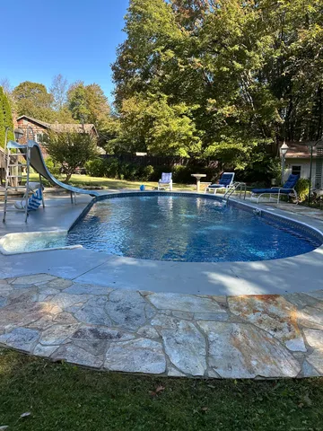 a view of a yard with swimming pool
