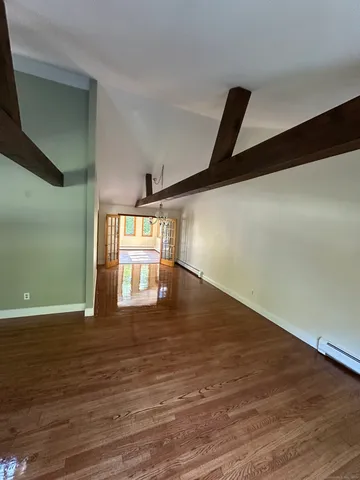 a room with wooden floor and windows
