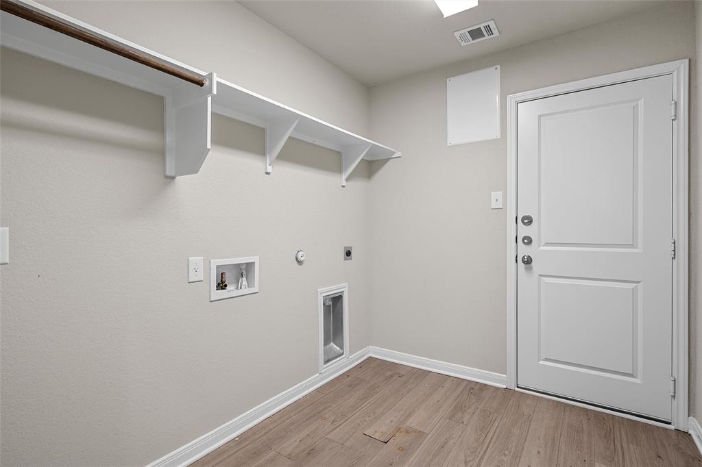 3224 Dottavio Road Lorena, TX 76655 - Photo 15 of 31 Dedicated laundry area featuring wood-finish flooring, white baseboards, and light neutral wall paint