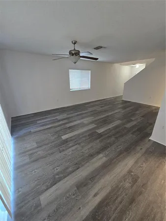 a view of a room with wooden floor