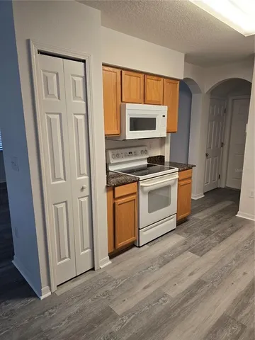 a kitchen with a stove top oven and sink