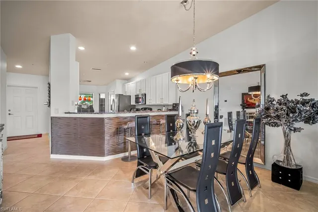 a view of a dining room with furniture and a chandelier