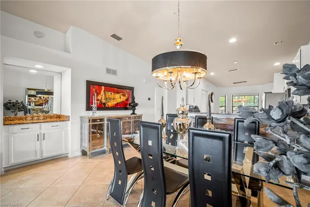 a view of a dining room kitchen and a chandelier