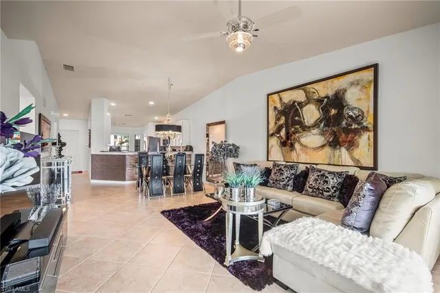 a living room with furniture and a view of kitchen