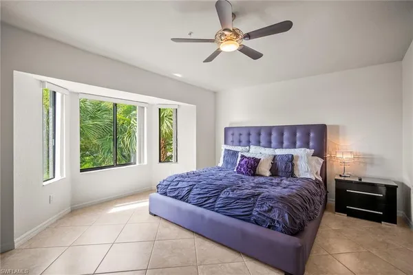 a living room with a bed furniture and a large window