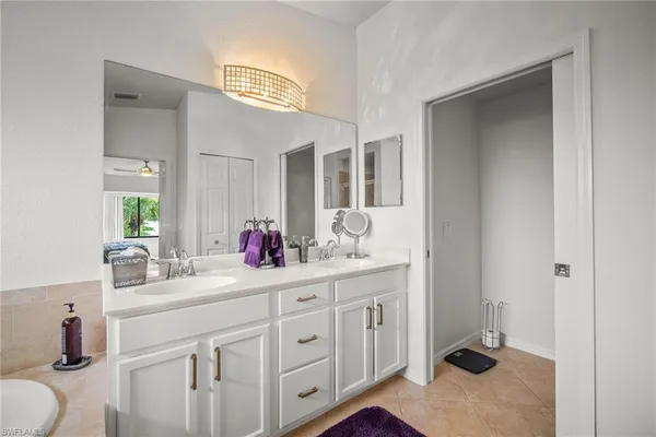 a bathroom with a sink vanity and mirror