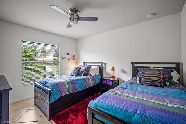 a bedroom with two beds and a window