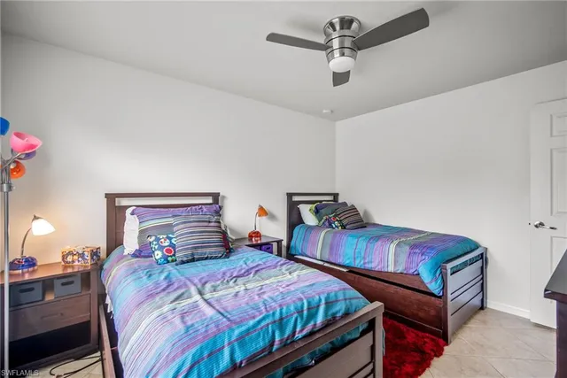 a bedroom with two beds and a chandelier