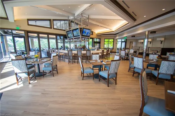 a view of a dining hall with lots of furniture and wooden floor
