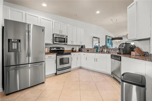a kitchen with stainless steel appliances a refrigerator sink and microwave