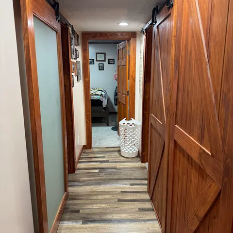 a view of a hallway with a livingroom and furniture