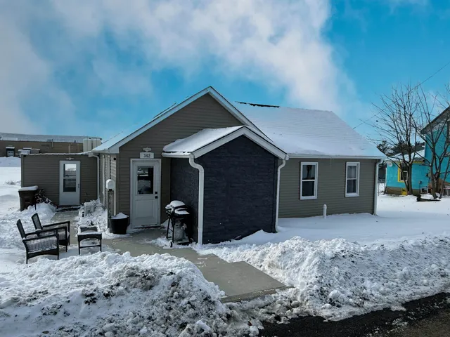 a front view of house with yard outdoor seating and barbeque oven