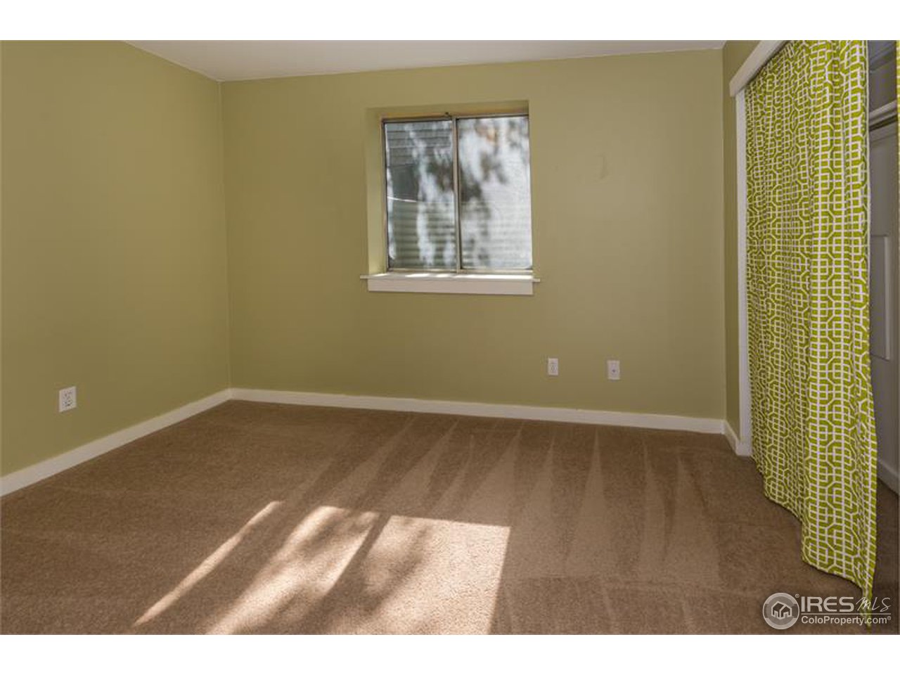 711 East Baseline Road Lafayette, CO 80026 - Photo 10 of 21 a view of an empty room with wooden floor and a window