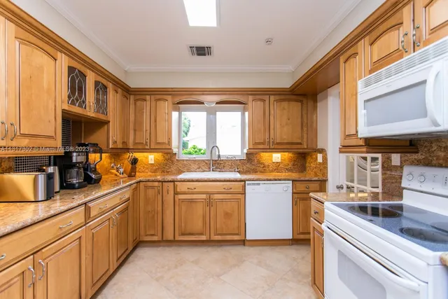 a kitchen with stainless steel appliances granite countertop a sink and cabinets