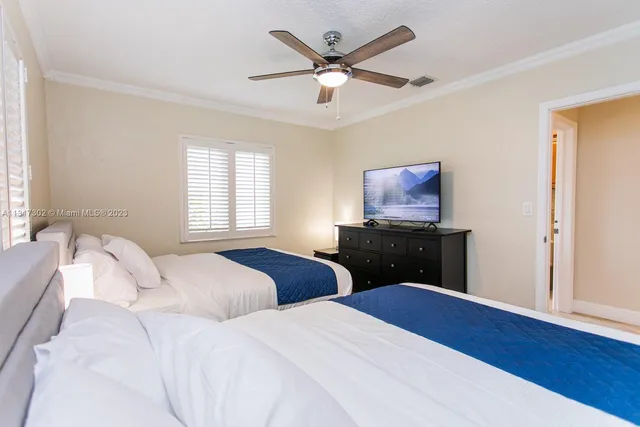 a bedroom with two beds and a window