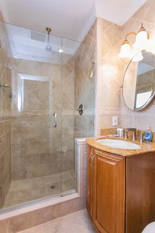 a bathroom with a sink vanity and a mirror