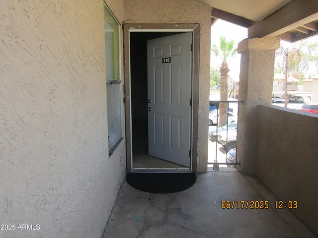a view of a hallway with wooden floor and a window