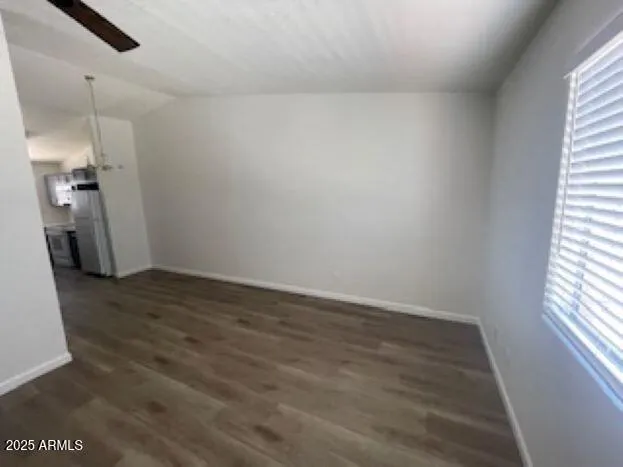 a view of a room with wooden floor and a window
