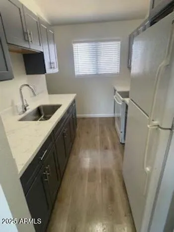 a kitchen with sink a microwave a stove and refrigerator