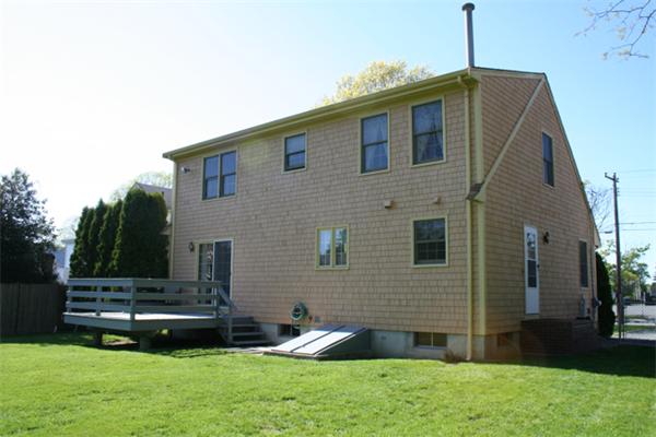 91 Spring Street Fairhaven, MA 02719 - Photo 7 of 30 a front view of a house with a garden