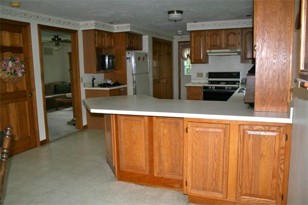 91 Spring Street Fairhaven, MA 02719 - Photo 9 of 30 a kitchen with stainless steel appliances a refrigerator and a stove