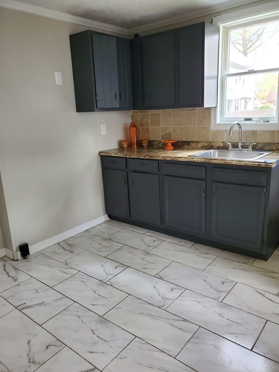 80-84 Keith Street Springfield, MA 01108 - Photo 3 of 4 a kitchen with a cabinets and window