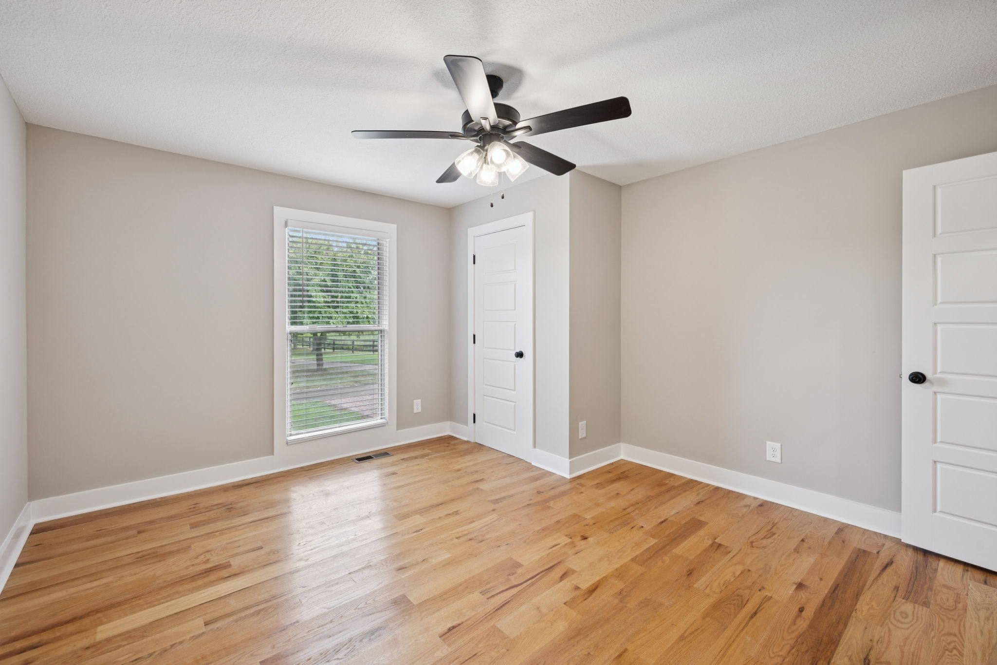 3935 Harmony Grove Road Hopkinsville, KY 42240 - Photo 20 of 64 a view of an empty room with wooden floor and a window