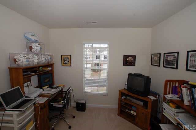 7038 Racine Way Raleigh, NC 27615 - Photo 2 of 12 a view of a workspace with furniture and a window