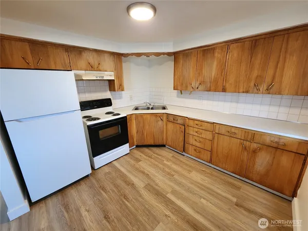a kitchen with stainless steel appliances granite countertop a stove a sink dishwasher and a refrigerator