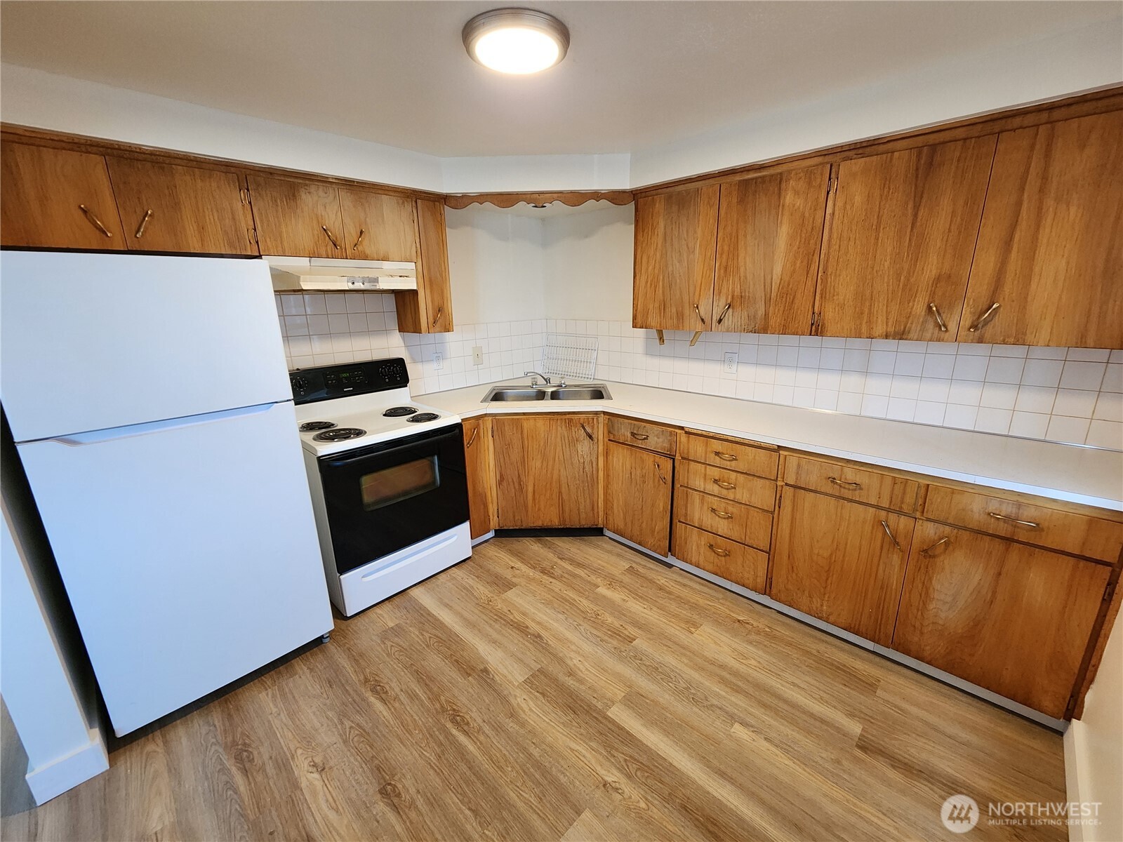 6615 North Atlantic Street Spokane, WA 99208 - Photo 16 of 22 a kitchen with stainless steel appliances granite countertop a stove a sink dishwasher and a refrigerator