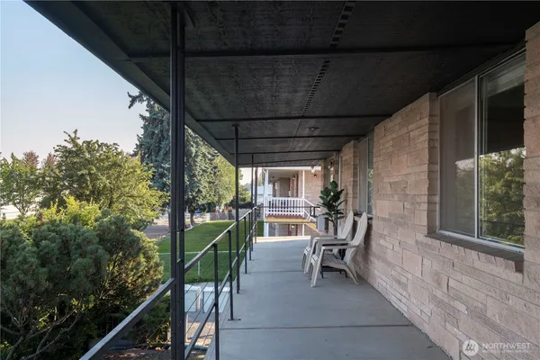 a view of two chairs in the balcony