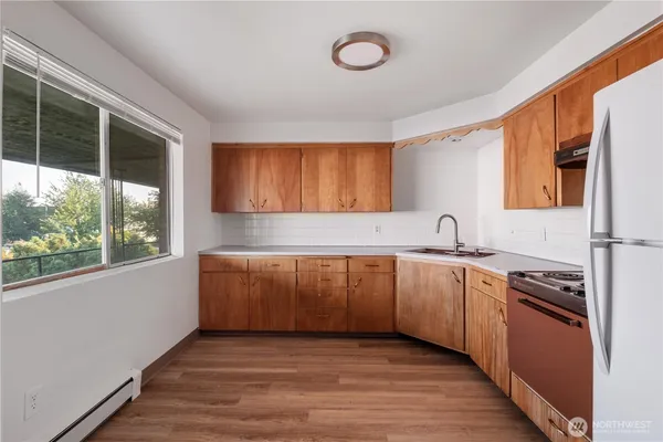 a kitchen with a stove a sink and a refrigerator