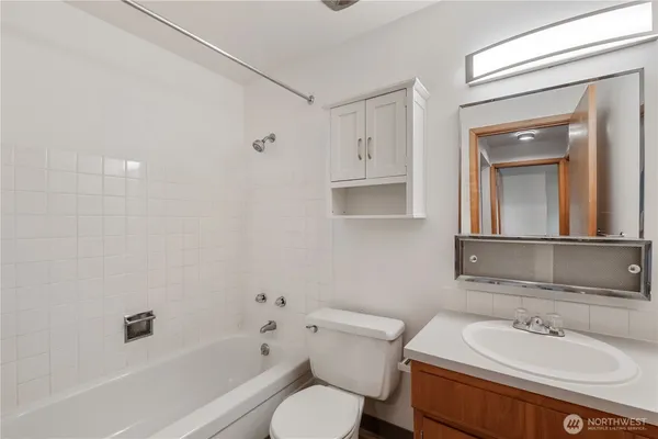 a bathroom with a sink toilet a mirror and shower