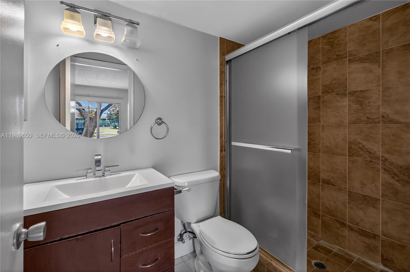400 Southwest 134th Way, Unit 112F Pembroke Pines, FL 33027 - Photo 14 of 40 a bathroom with a sink mirror toilet and vanity