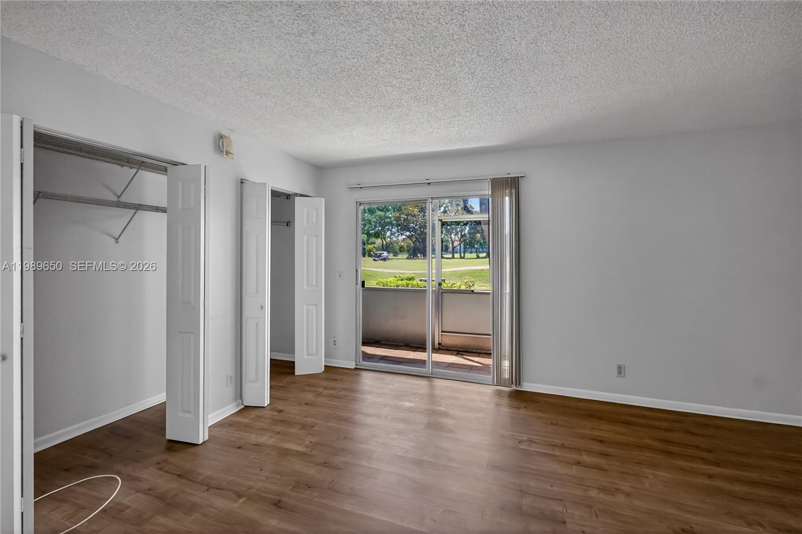 400 Southwest 134th Way, Unit 112F Pembroke Pines, FL 33027 - Photo 16 of 40 an empty room with wooden floor and entrance