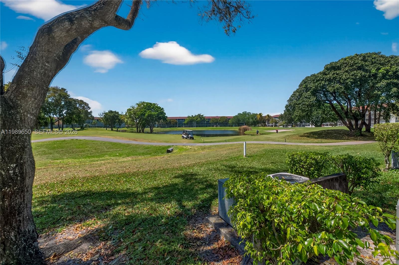 400 Southwest 134th Way, Unit 112F Pembroke Pines, FL 33027 - Photo 18 of 40 a view of a golf course with a lake